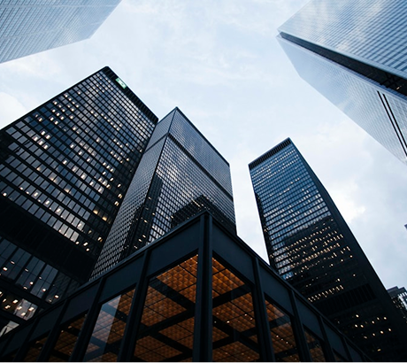 Tall modern office buildings viewed from below.